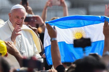 A worshiper waves the flag of Argentina as Pope Francis arrives for the weekly general audience on June 5, 2019 at St. Peter's square in the Vatican.