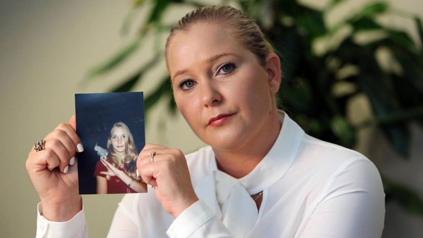 Virginia Giuffre holds a photo of herself as a teen.