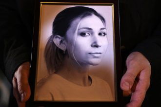 A colleague of Ukrainian journalist Victoria Roshchyna holds a photograph of her during an event in honor of her memory in Kyiv, on October 11, 2024.