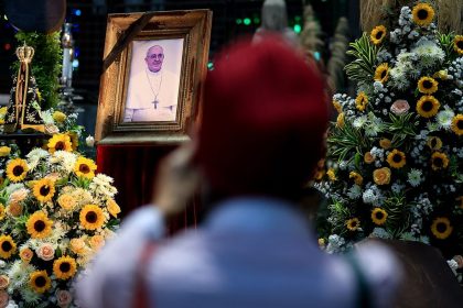 A faithful takes photos of a portrait of the late Pope Francis displayed at the Rio de Janeiro Metropolitan Cathedral on April 21, 2025 in Rio de Janeiro, Brazil.