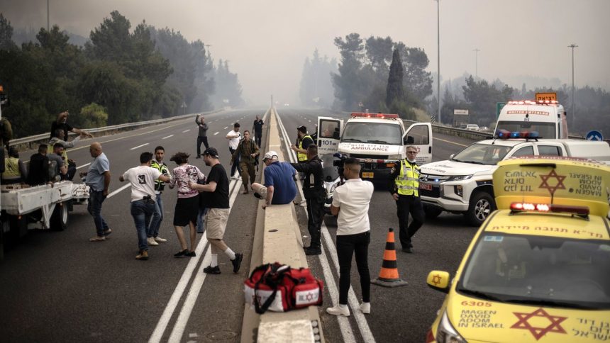 Security forces take precautions and close roads in response to a wildfire that broke out in a forested area between Tel Aviv and Jerusalem on Wednesday.