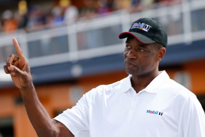 NBA Legend Dikembe Mutombo stands at the NASCAR Cup Series Kobalt 400 at Las Vegas Motor Speedway on March 10, 2017.