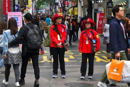 South Korean tourist information guides patrol popular neighborhoods to help answer tourists' questions.