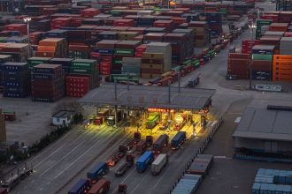 TOPSHOT - Trucks and shipping containers are seen at a port in Nanjing, in eastern China's Jiangsu province on April 8, 2025. US President Donald Trump forged ahead with tariffs of over 100 percent against Chinese goods after Beijing refused to withdraw its retaliation as the world's biggest economies go head-to-head in a ruinous trade war that has rocked global markets. (Photo by STRINGER / AFP) / China OUT (Photo by STRINGER/AFP via Getty Images)
