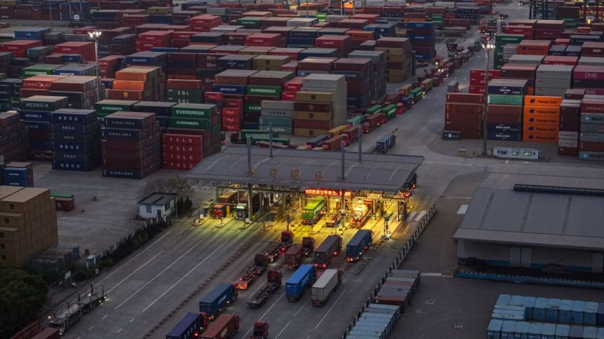 TOPSHOT - Trucks and shipping containers are seen at a port in Nanjing, in eastern China's Jiangsu province on April 8, 2025. US President Donald Trump forged ahead with tariffs of over 100 percent against Chinese goods after Beijing refused to withdraw its retaliation as the world's biggest economies go head-to-head in a ruinous trade war that has rocked global markets. (Photo by STRINGER / AFP) / China OUT (Photo by STRINGER/AFP via Getty Images)