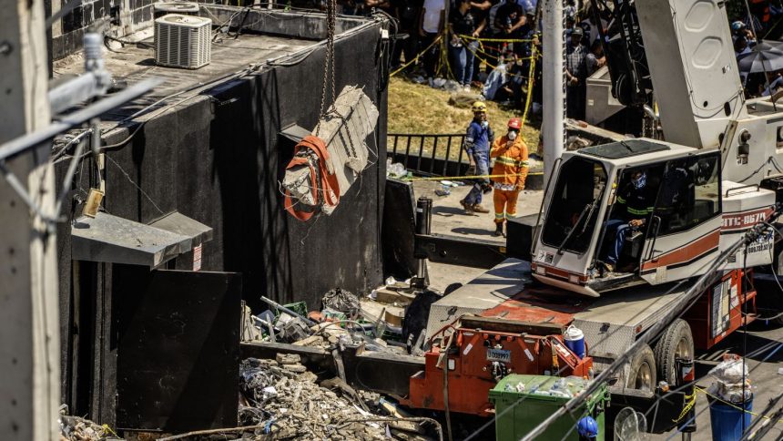 Personnel from civil defense and firefighters work at the Jet Set nightclub following the collapse of its roof in Santo Domingo on April 8, 2025.