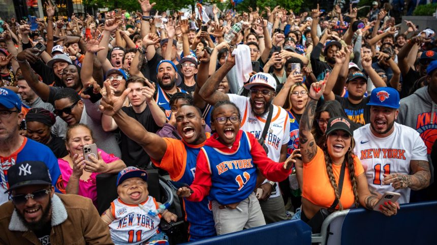 Tyler McCoy and his son Isaiah cheer for the New York Knicks at the watch party for Game 4 of round 2 of the NBA playoffs between the New York Knicks and Boston Celtics outside of Madison Square Garden on May 12.
