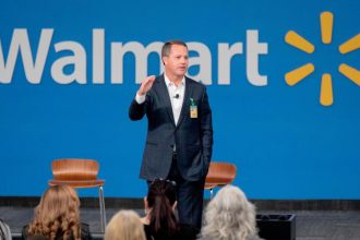 IMAGE DISTRIBUTED FOR WALMART - Walmart President and CEO, Doug McMillon, announced today that Walmart will give hiring preference to military spouses, becoming the largest U.S. company to make such a commitment. This announcement came during a Veterans Day ceremony on Monday, Nov. 12, 2018 in Bentonville, Ark. (Gareth Patterson/AP Images for Walmart)