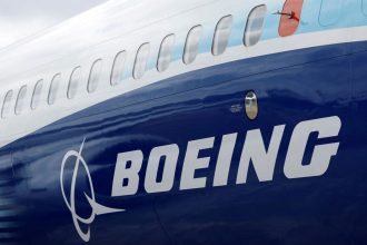 The Boeing logo is seen on the side of a Boeing 737 MAX at the Farnborough International Airshow in Farnborough, Britain, on July 20, 2022.