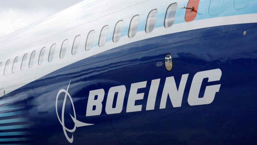 The Boeing logo is seen on the side of a Boeing 737 MAX at the Farnborough International Airshow in Farnborough, Britain, on July 20, 2022.