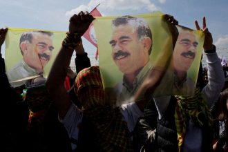 Supporters of pro-Kurdish Peoples' Equality and Democracy Party display flags with a portrait of jailed Kurdistan Workers Party leader Abdullah Ocalan during a rally in Istanbul, Turkey, in March 2024.