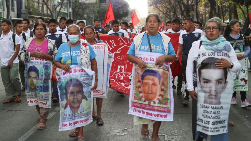 Students follow relatives of the 43 missing students of Ayotzinapa Rural Teachers' College and members of collectives of relatives of missing persons during the Ayotzinapa's monthly march to demand justice in Mexico City, Mexico.