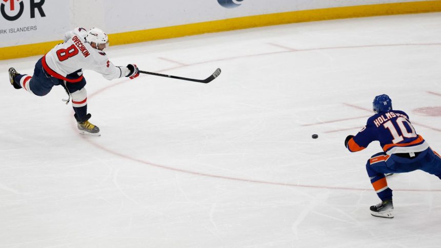 Washington Capitals left wing Alex Ovechkin scores a goal in the second period against the New York Islanders at UBS Arena. The goal was the 895th of Ovechkin’s career, breaking the NHL all-time career goals record.