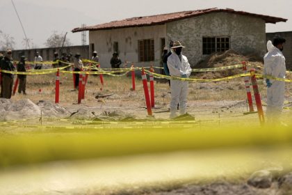 Forensic technicians stand at a cordoned area during a media tour by Jalisco's Attorney General Office at Izaguirre Ranch in March. Activists have called the property a cartel-run "extermination camp."