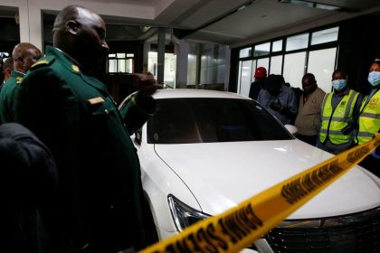 Kenyan parliamentary staff and forensic experts secure the vehicle in which slain Kenyan lawmaker Charles Were was shot dead by gunmen in Nairobi on April 30, 2025.