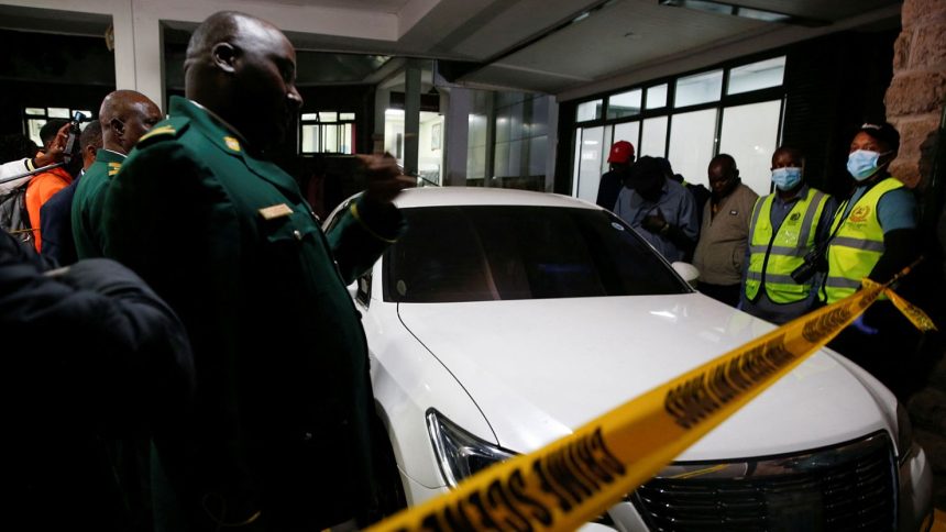 Kenyan parliamentary staff and forensic experts secure the vehicle in which slain Kenyan lawmaker Charles Were was shot dead by gunmen in Nairobi on April 30, 2025.