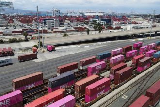Shipping containers sit on rail road tracks at the Port of Long Beach in Long Beach, California.