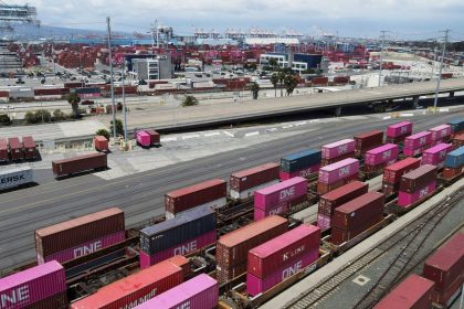 Shipping containers sit on rail road tracks at the Port of Long Beach in Long Beach, California.