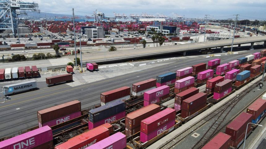 Shipping containers sit on rail road tracks at the Port of Long Beach in Long Beach, California.