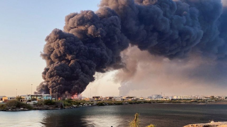 A large plume of smoke rises from a fuel depot in Port Sudan, Sudan, on May 6, 2025.