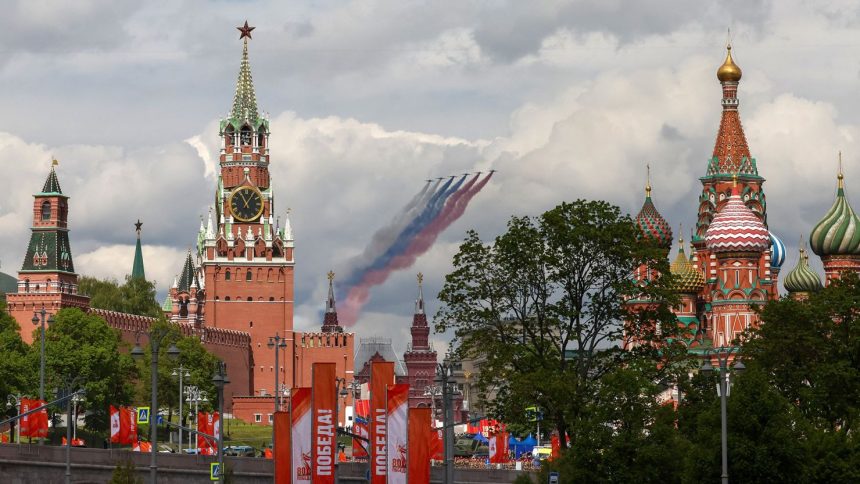 Russia's Su-25 jet aircraft release smoke in the colours of the Russian state flag while flying towards the Kremlin and St. Basil’s Cathedral during a rehearsal in Moscow on Wednesday for the May 9 parade.