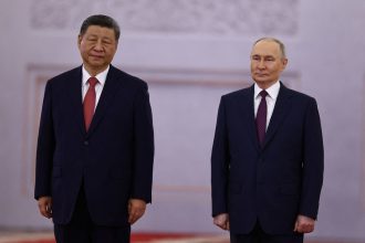 Russian President Vladimir Putin welcomes Chinese leader Xi Jinping before their talks at the Kremlin in Moscow on May 8.