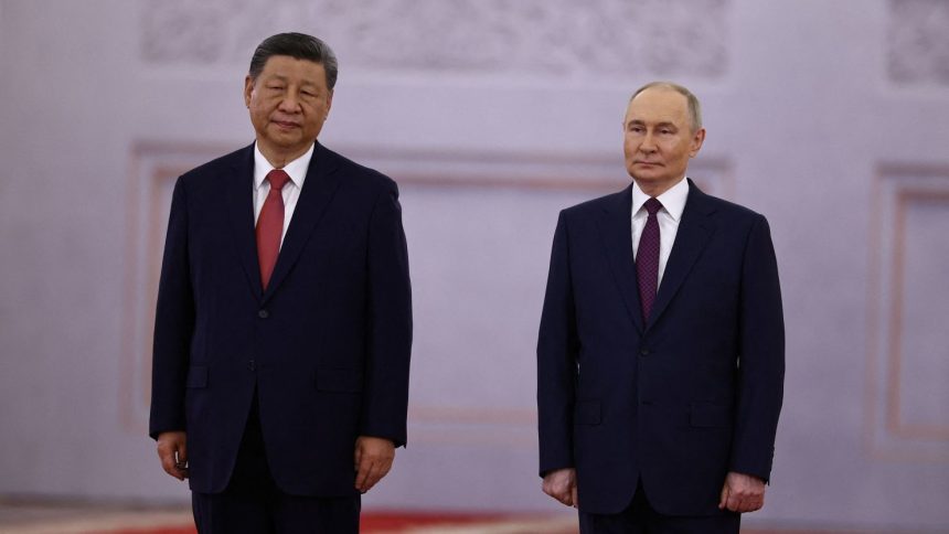 Russian President Vladimir Putin welcomes Chinese leader Xi Jinping before their talks at the Kremlin in Moscow on May 8.