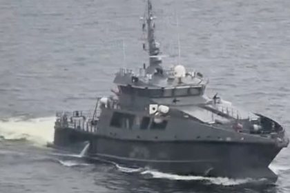 An Estonian military vessel sails near a Russian-bound oil tanker at sea, Gulf of Finland, in this screengrab taken from social media, May 13, 2025.