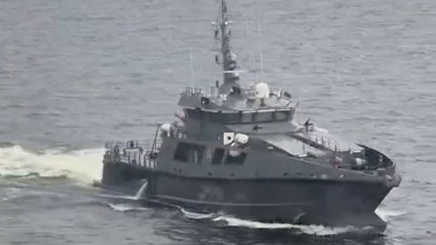 An Estonian military vessel sails near a Russian-bound oil tanker at sea, Gulf of Finland, in this screengrab taken from social media, May 13, 2025.