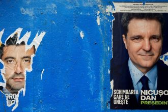 A torn poster featuring presidential candidate George Simion is seen next to one of Nicusor Dan ahead of the second round of the presidential elections, in Bucharest, Romania, on May 16, 2025.