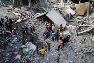 Palestinians inspect the site of an Israeli strike in Jabalya, northern Gaza on May 18, 2025.