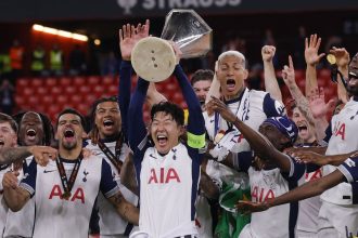 Tottenham captain Son Heung-min lifts the Europa League trophy following Spurs' victory in the final.