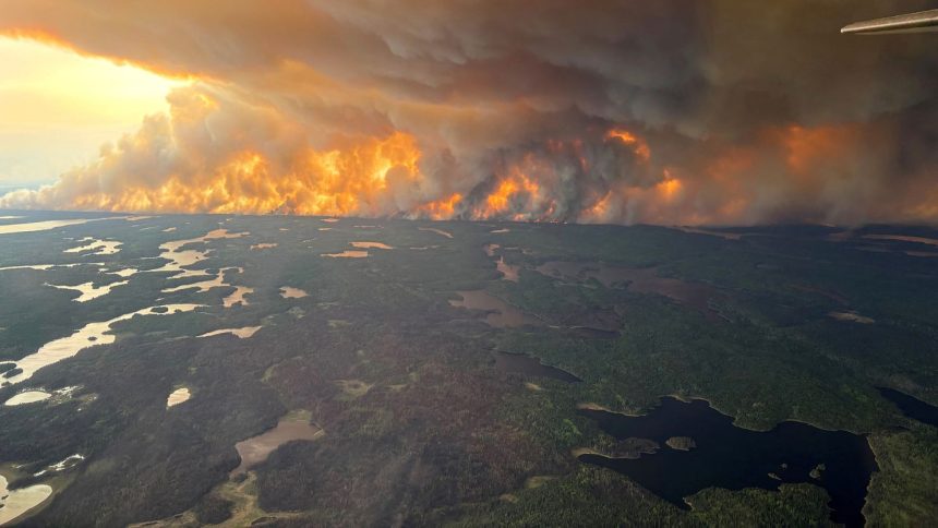 Smoke rises from wildfire WE024 in Flin Flon, Manitoba, Canada on May 27.