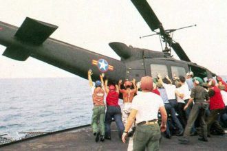 A helicopter is pushed over the side of the aircraft carrier the USS Midway on April 29, 1975.