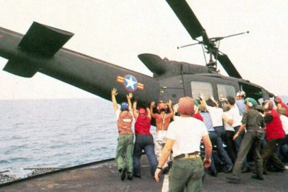 A helicopter is pushed over the side of the aircraft carrier the USS Midway on April 29, 1975.