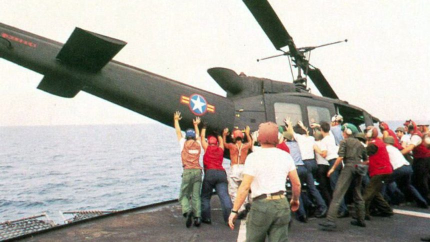A helicopter is pushed over the side of the aircraft carrier the USS Midway on April 29, 1975.