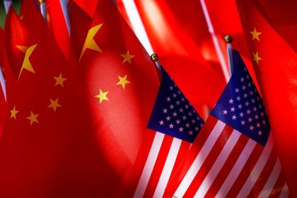 American flags are displayed together with Chinese flags on top of a trishaw in Beijing.