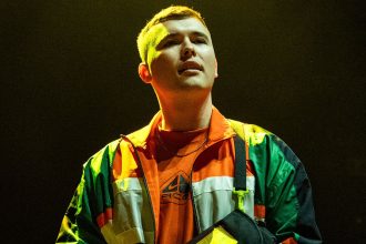 Liam O'Hanna, whose stage name is Mo Chara, performs with Kneecap on March 17, 2024, in Boston.