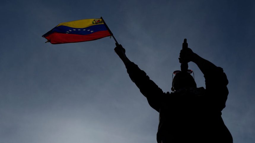 A man holding a Venezuelan flag sings at a government-organized rally against US deportations in Caracas, Venezuela on April 2.