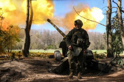 A Russian serviceman of the 30th Motorized Rifle Regiment fires a М-46 howitzer toward Ukrainian positions in Kursk region, Russia.