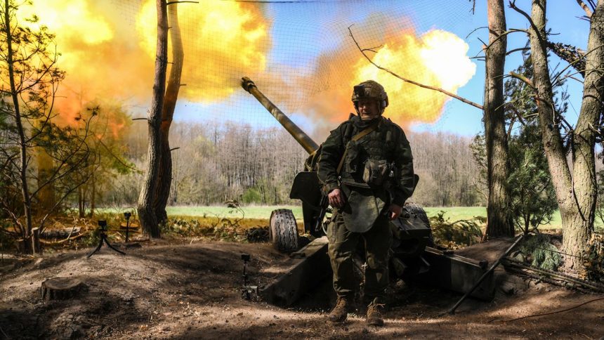 A Russian serviceman of the 30th Motorized Rifle Regiment fires a М-46 howitzer toward Ukrainian positions in Kursk region, Russia.