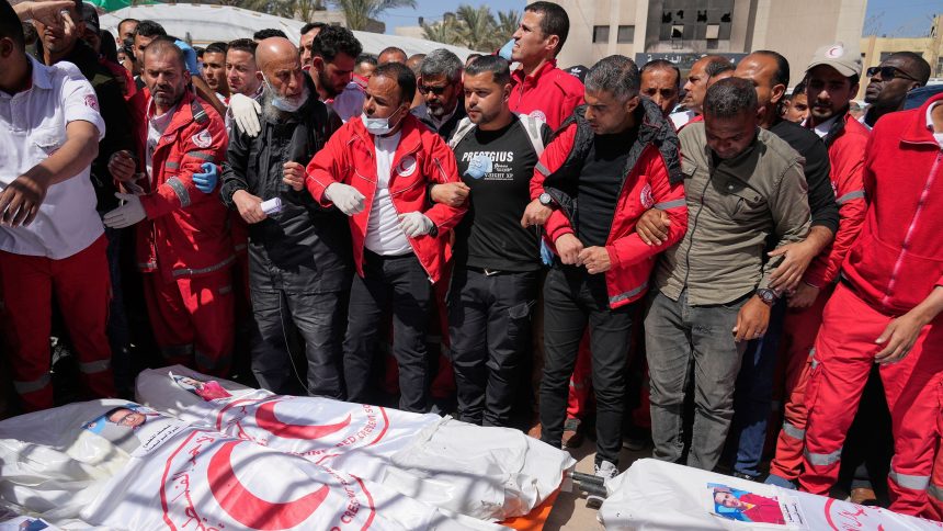 Mourners gather around the bodies of 8 Red Crescent emergency responders recovered in Rafah on March 31, 2025.