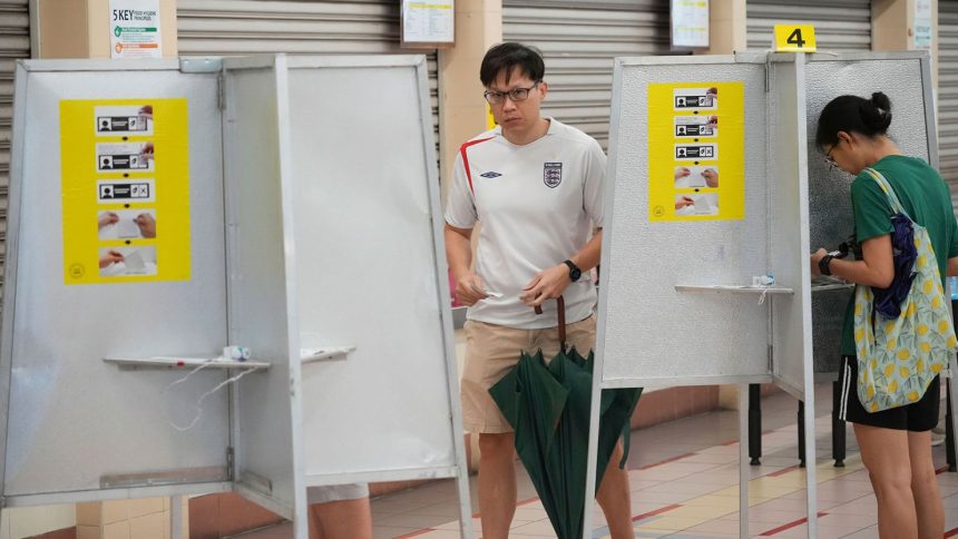 Singaporean voters cast their vote for general election at polling station in Singapore on May 3, 2025.
