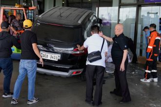 Airport authorities help first responders after a driver crashed an SUV into the entrance at Manila's International Airport Terminal 1 in Manila, Philippines, on Sunday, May 4, 2025.