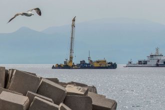 An Italian coast guard vessel and the Hebo Lift 2 floating crane off the coast of Sicily on Sunday, where the British superyacht Bayesian sunk in 2024.