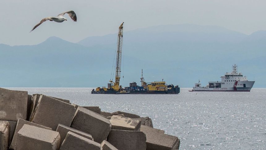 An Italian coast guard vessel and the Hebo Lift 2 floating crane off the coast of Sicily on Sunday, where the British superyacht Bayesian sunk in 2024.