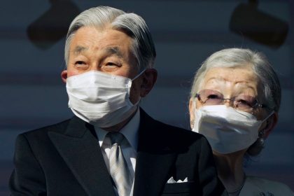 Japan's Emperor Emeritus Akihito and Empress Emerita Michiko greet well-wishers at the Imperial Palace in Tokyo on January 2, 2023.