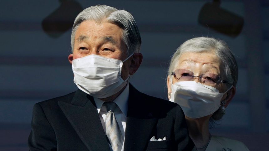Japan's Emperor Emeritus Akihito and Empress Emerita Michiko greet well-wishers at the Imperial Palace in Tokyo on January 2, 2023.