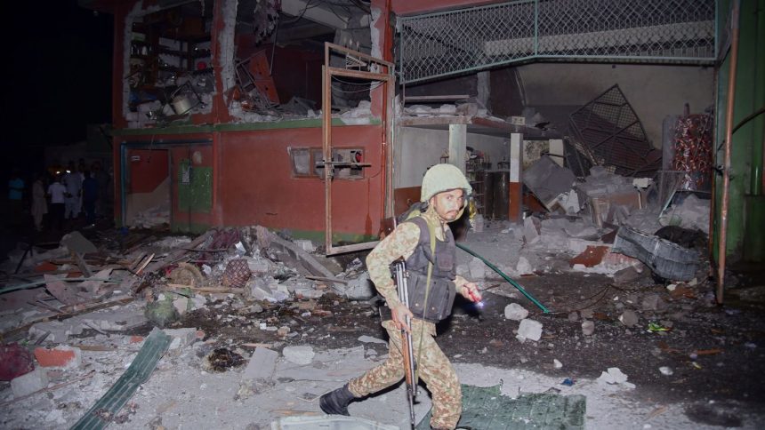 A soldier examines a building damaged by an Indian missile strike near Muzaffarabad in Pakistan-administered Kashmir on May 7, 2025.