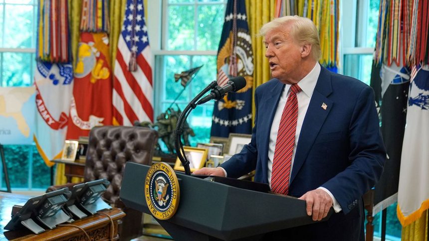 President Donald Trump speaks to reporters in the Oval Office.